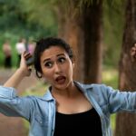 woman wears blue cardigan